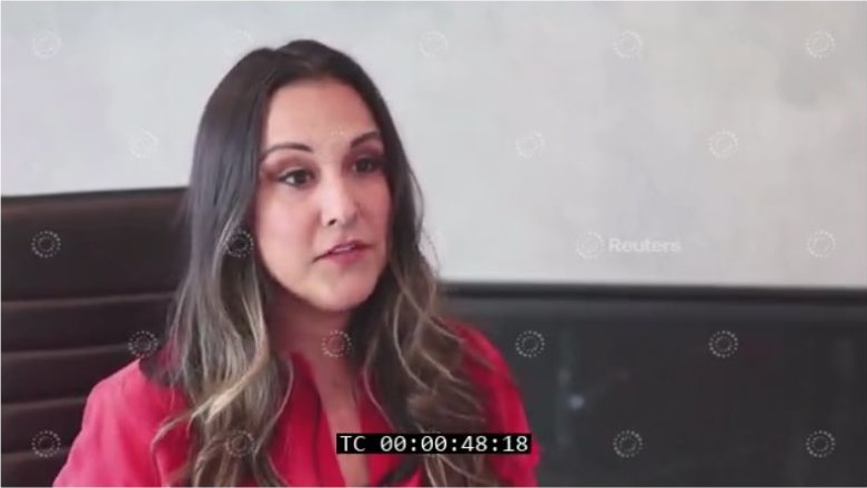Ariadna Jacob in a red blouse speaking in the Reuters interview, with original Reuters watermarks and source timecode.